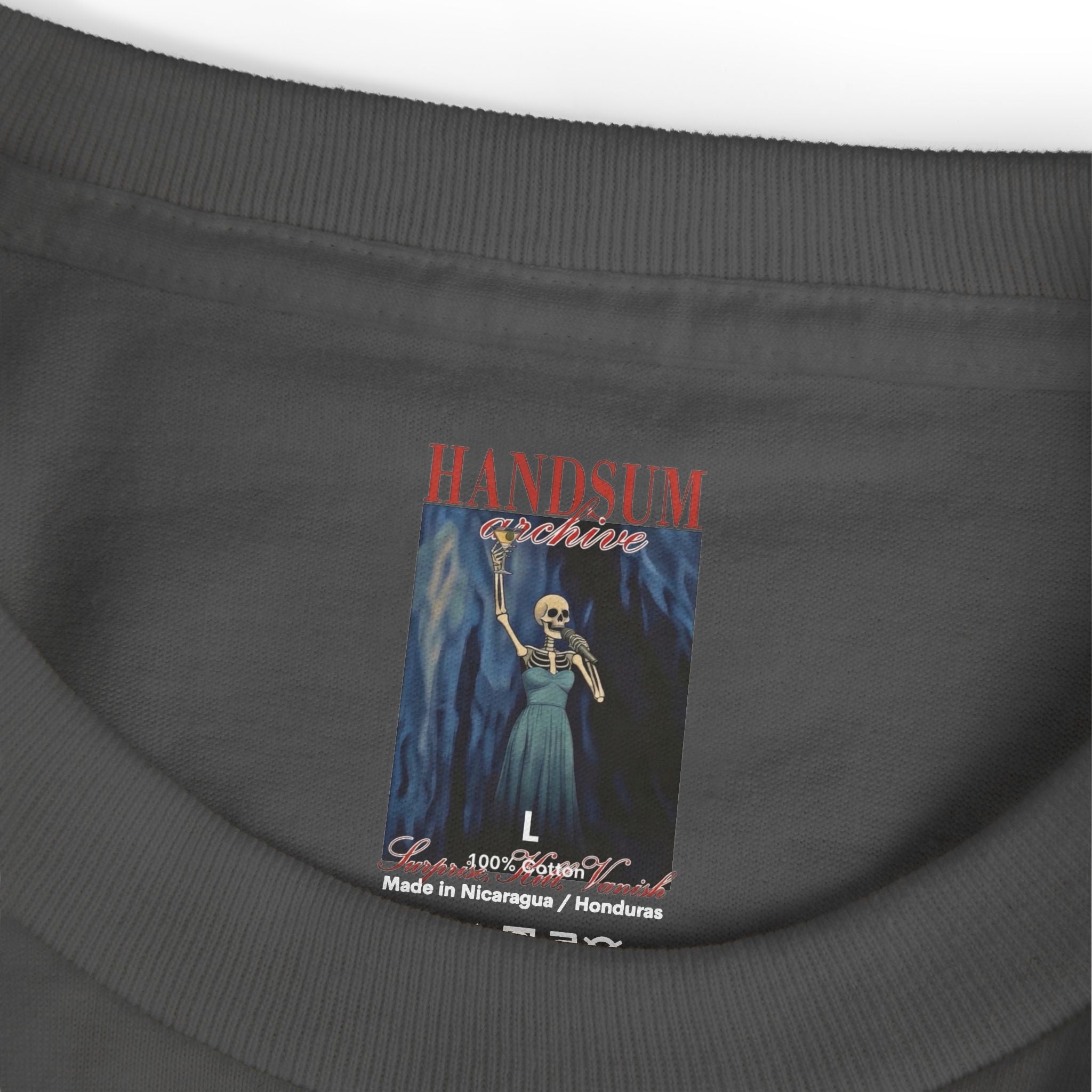 Dark gray T-shirt neck label showing “HANDSUN archive,” size L, and “Made in Nicaragua”