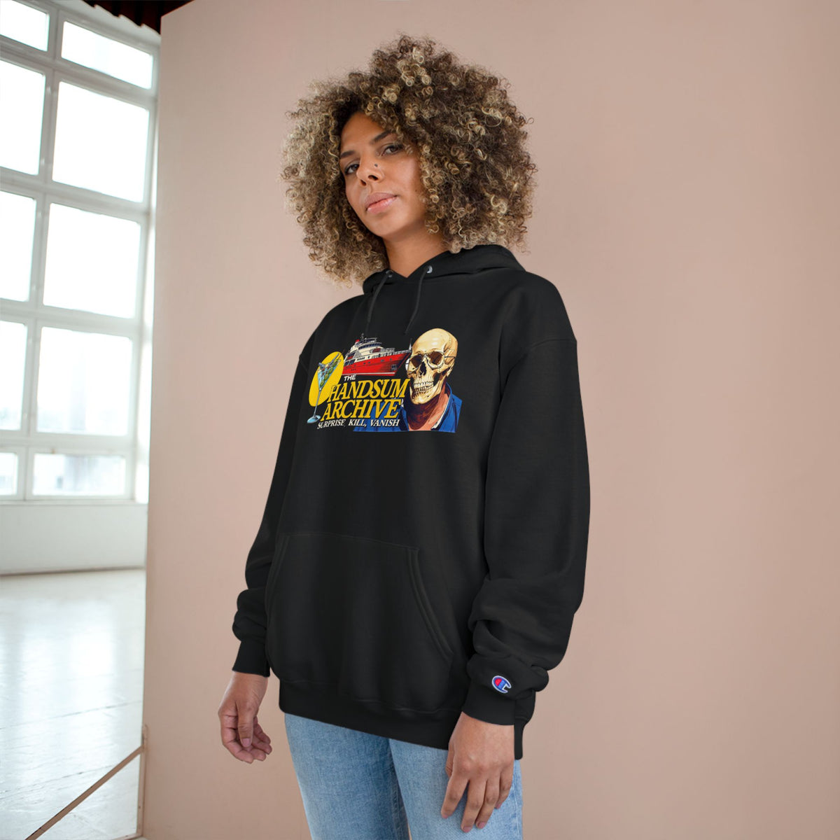 Black pullover hoodie with skull logo graphic on chest and kangaroo pocket, ribbed cuffs