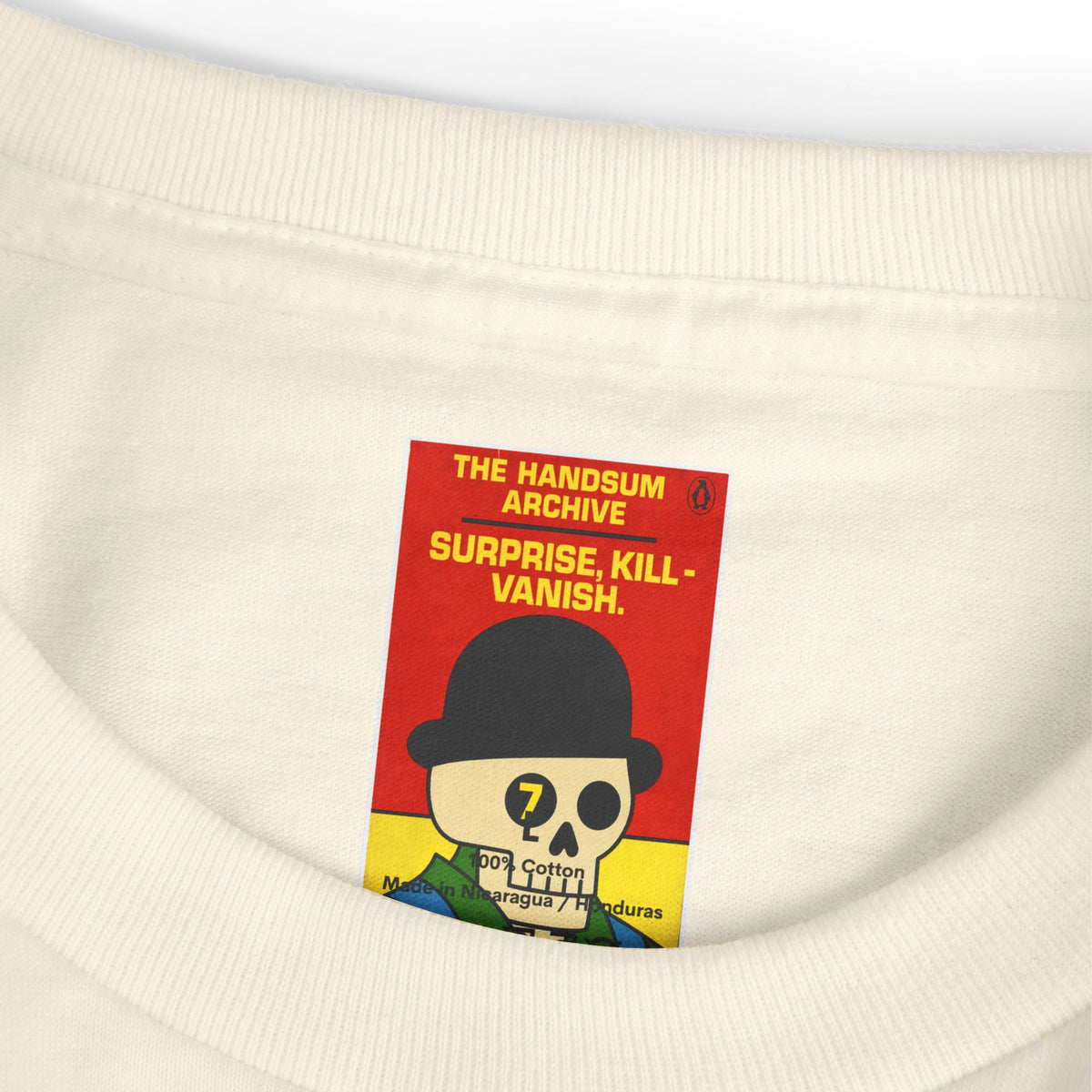 Faded cream T-shirt hem patch with red 'The Handsum Archive' text