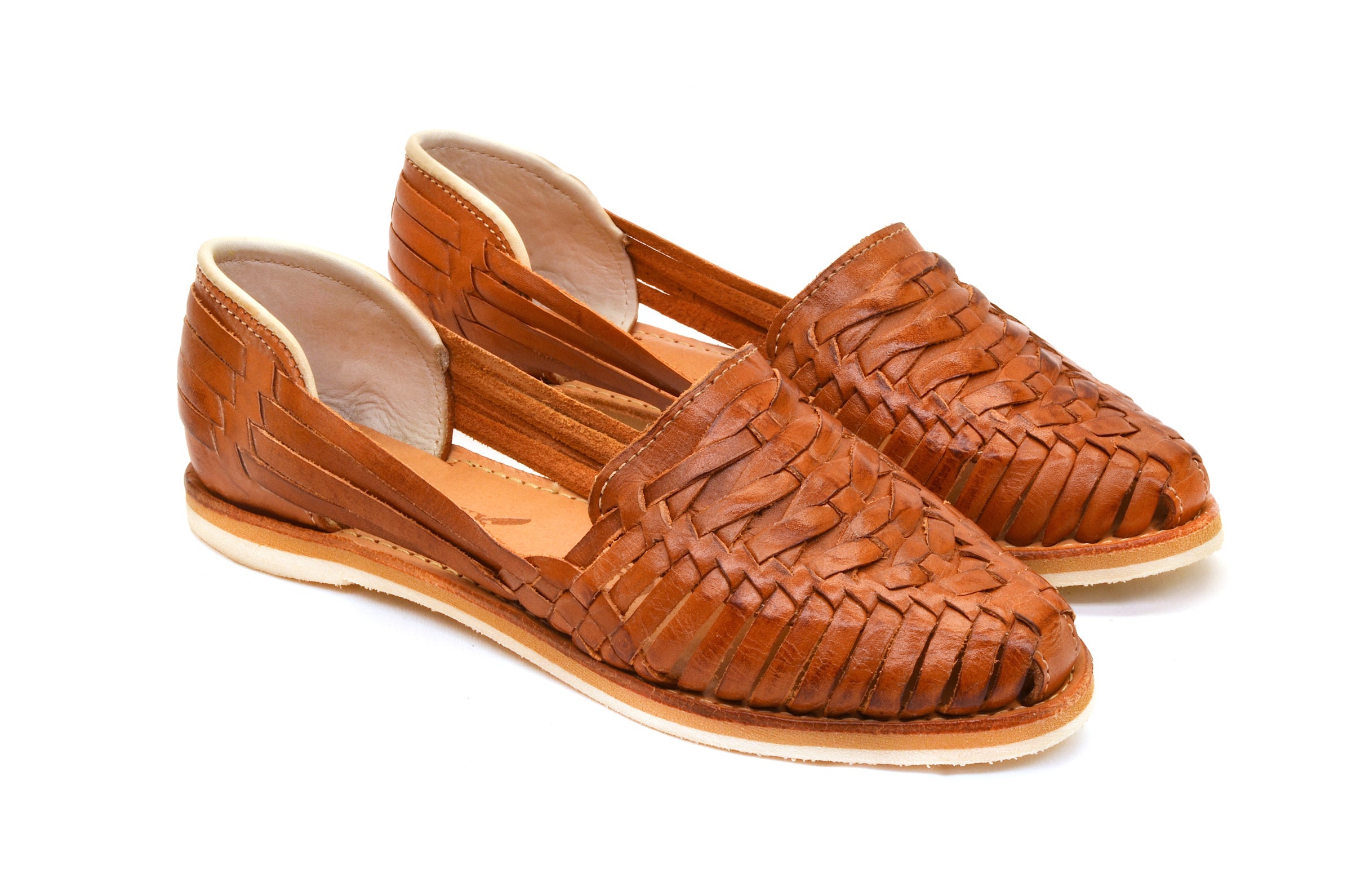 Brown woven huarache flat sandal with cross-stitch leather upper and slip-on fit