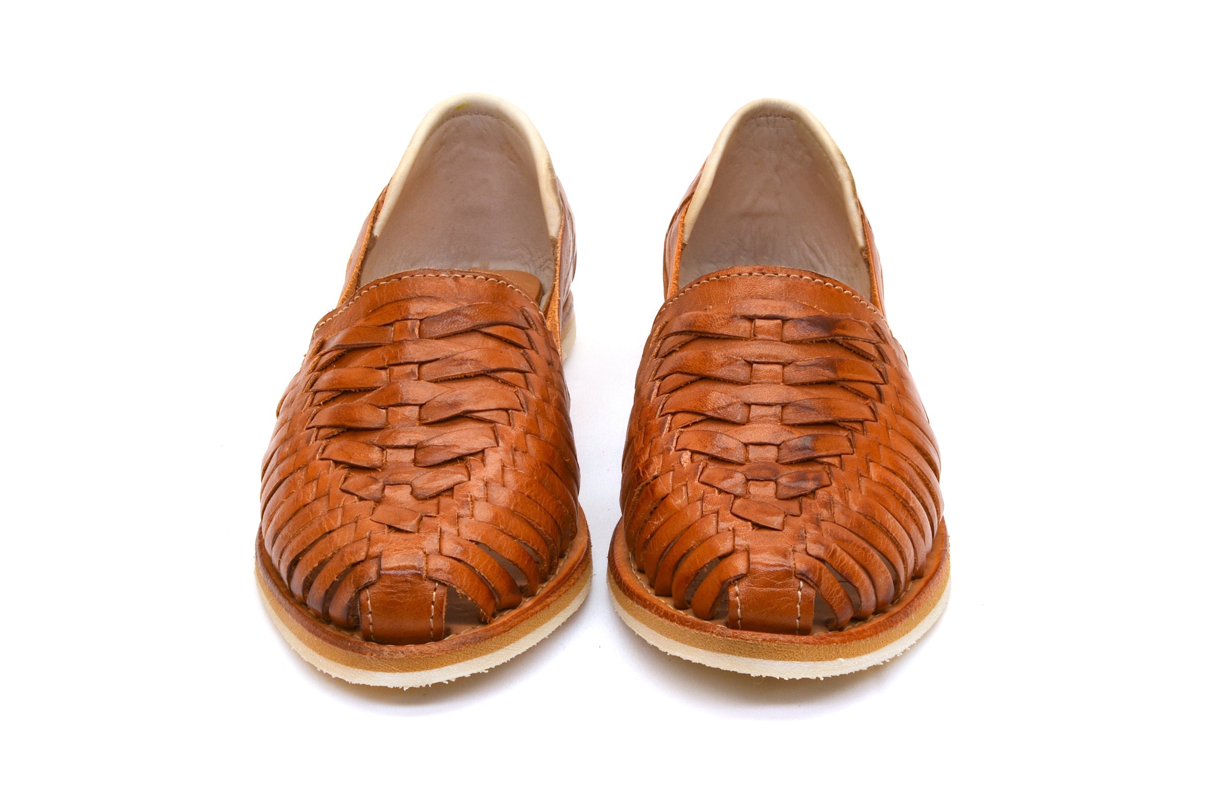 Brown woven leather huarache flats with crisscross pattern and rounded toe