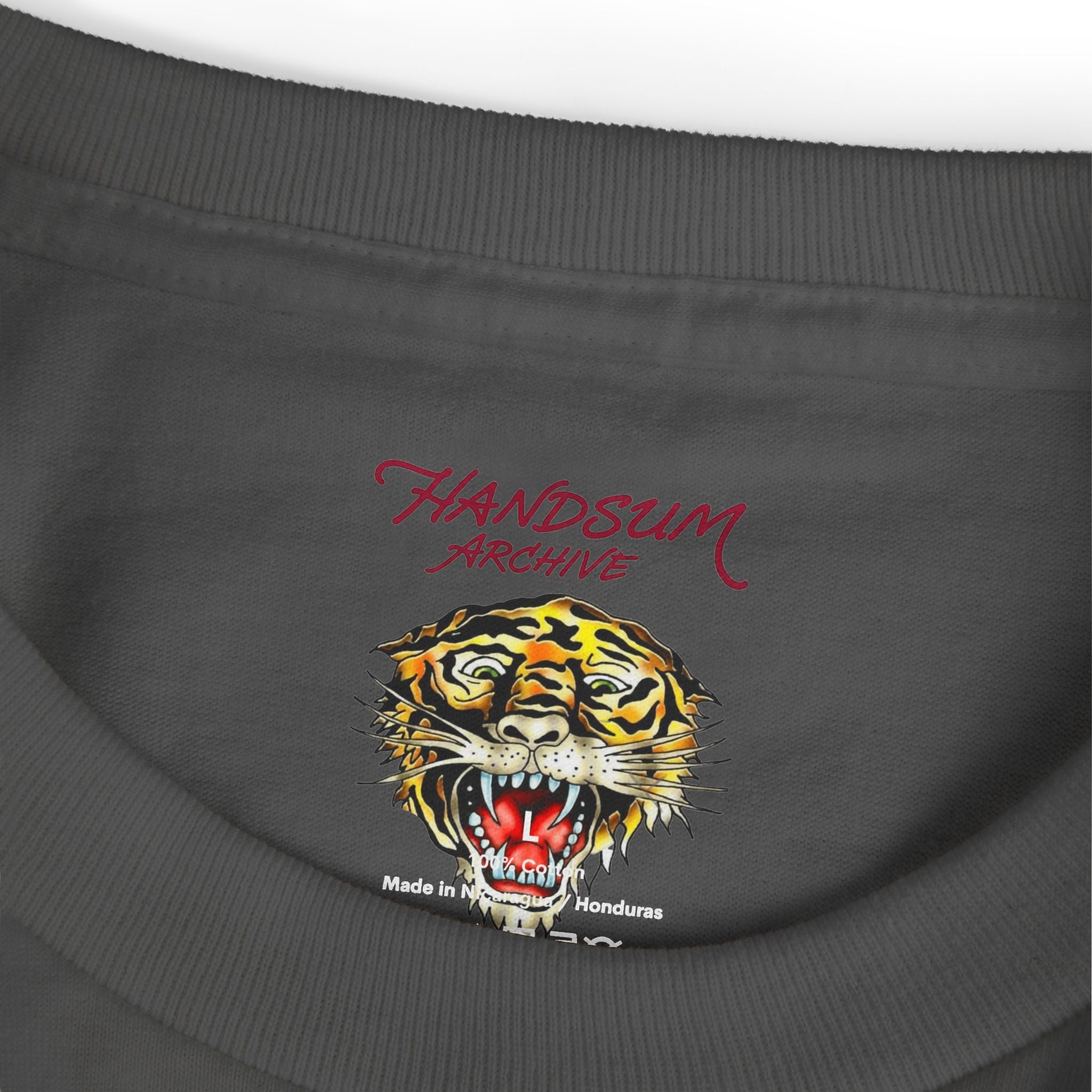 Dark gray T-shirt close-up with HANDSUM ARCHIVE text and tiger graphic at chest