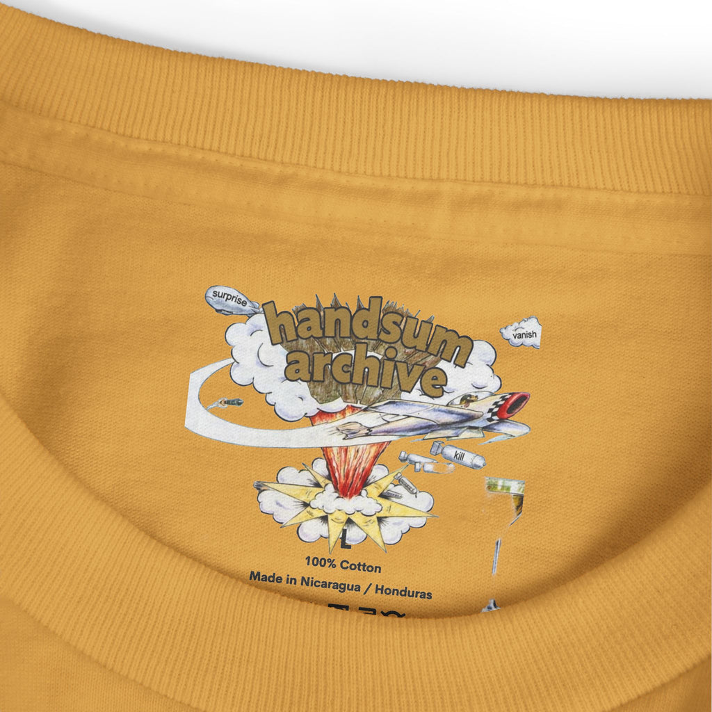 Gold-brown tee hem close-up with “100% Cotton” and “Handsum Archive” print.