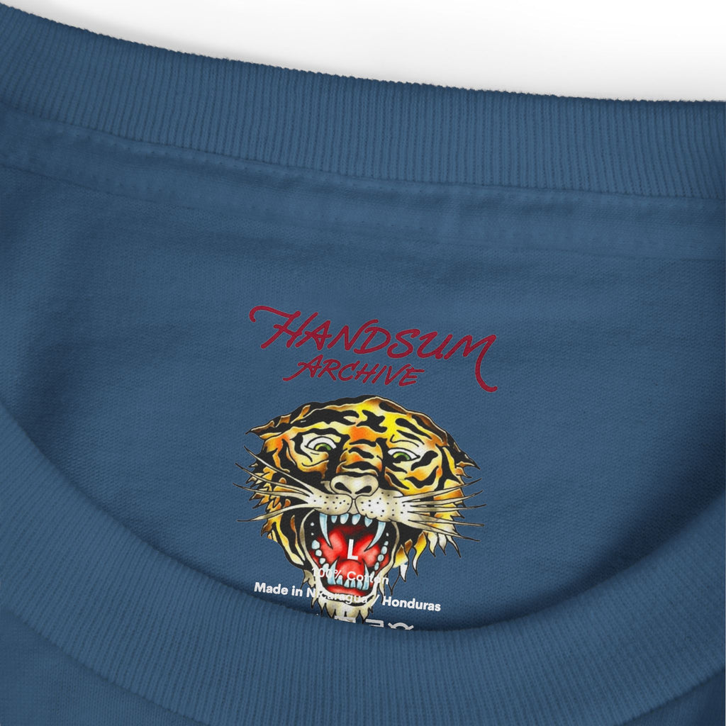 Faded blue T-shirt close-up with HANDSUM ARCHIVE text and roaring tiger graphic