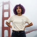 Cream crew-neck graphic T-shirt with tall monogram and small blue number 7