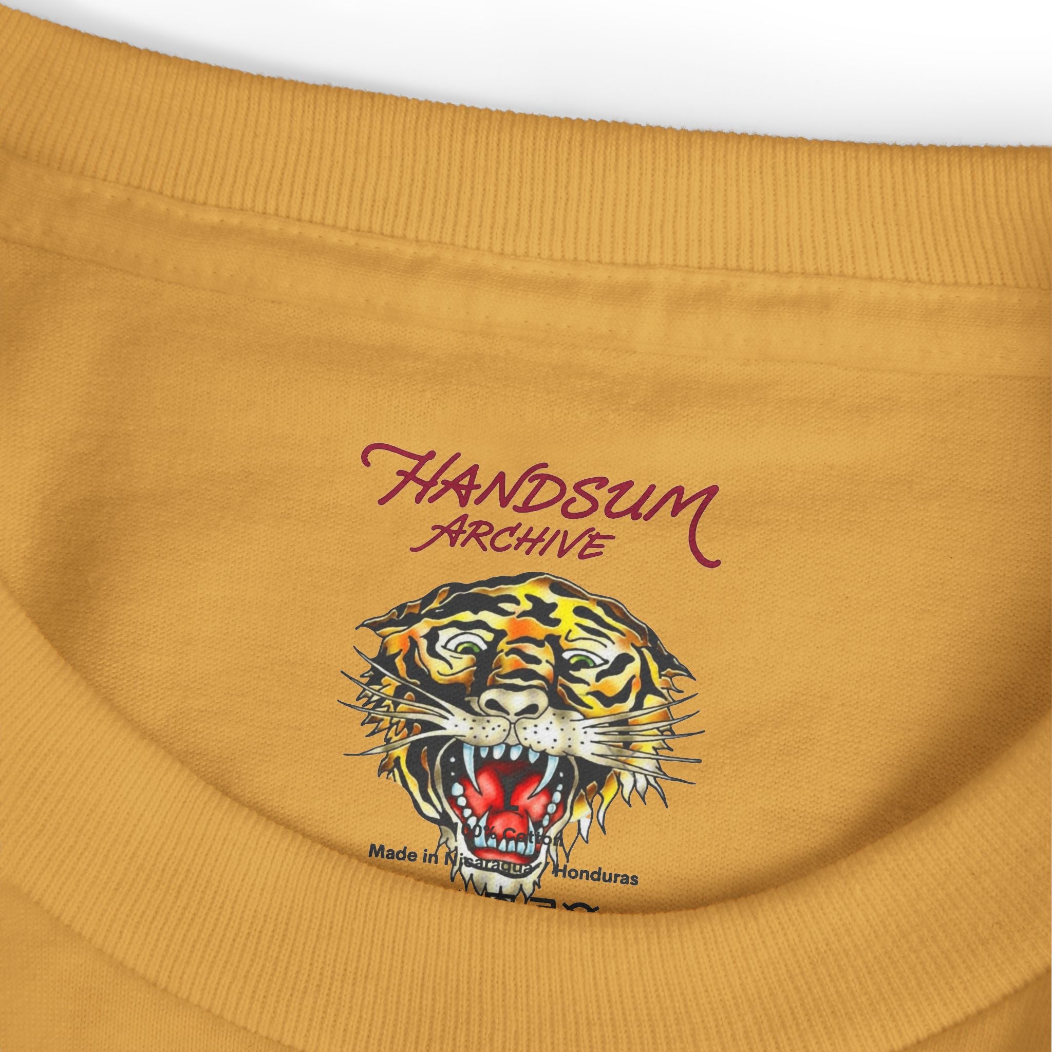Mustard T-shirt with tiger head graphic and Handsum Archive logo on the chest