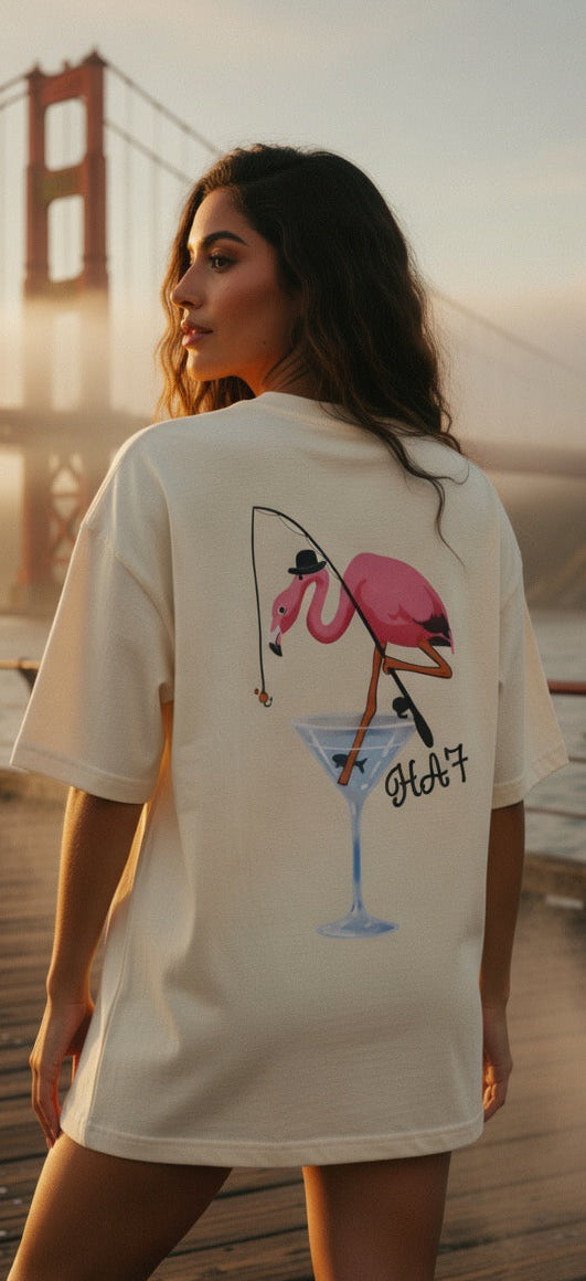 White graphic T-shirt with a pink flamingo martini illustration on the back.