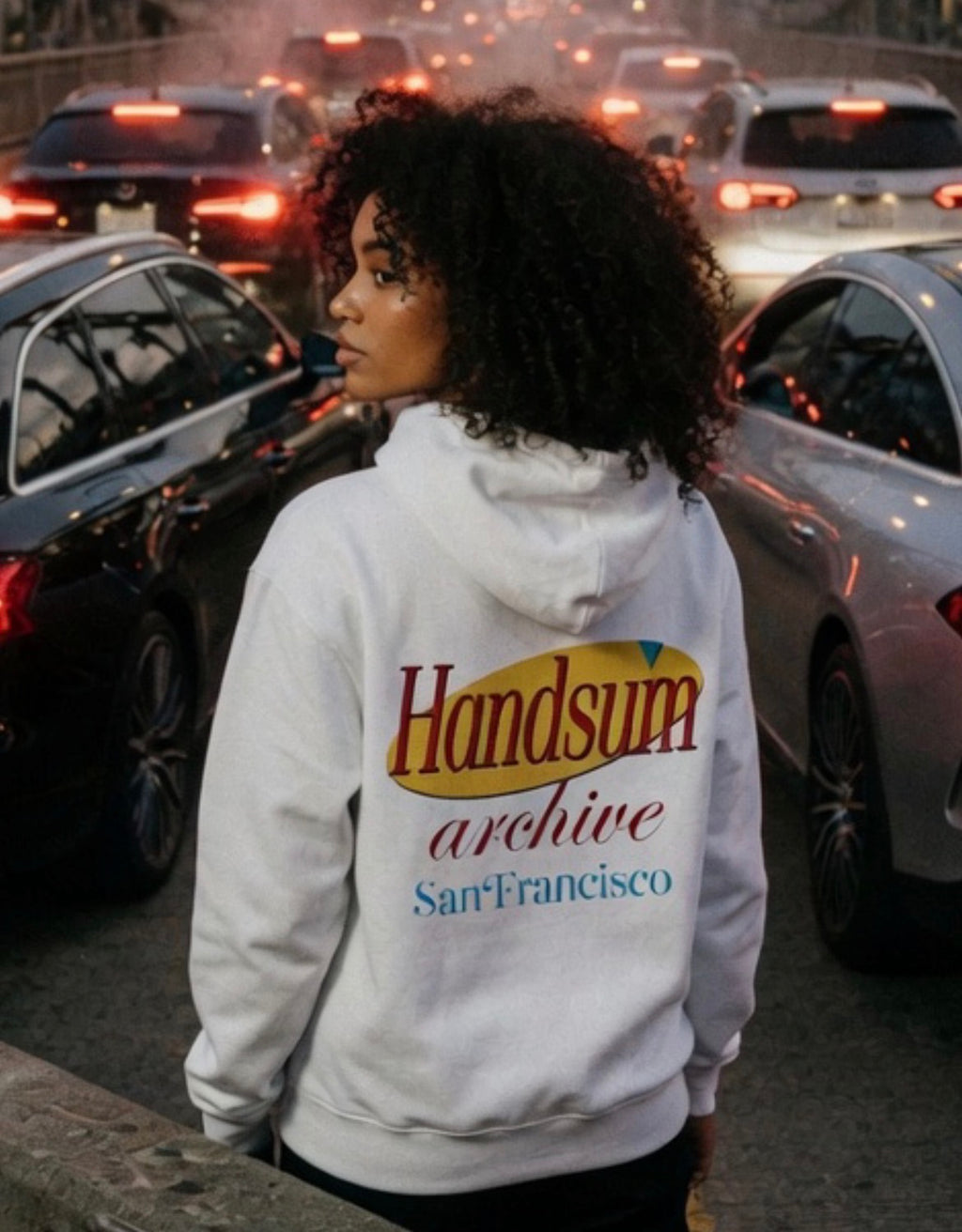 White hoodie with large back logo text "Handsfilm archive" and "San Francisco".