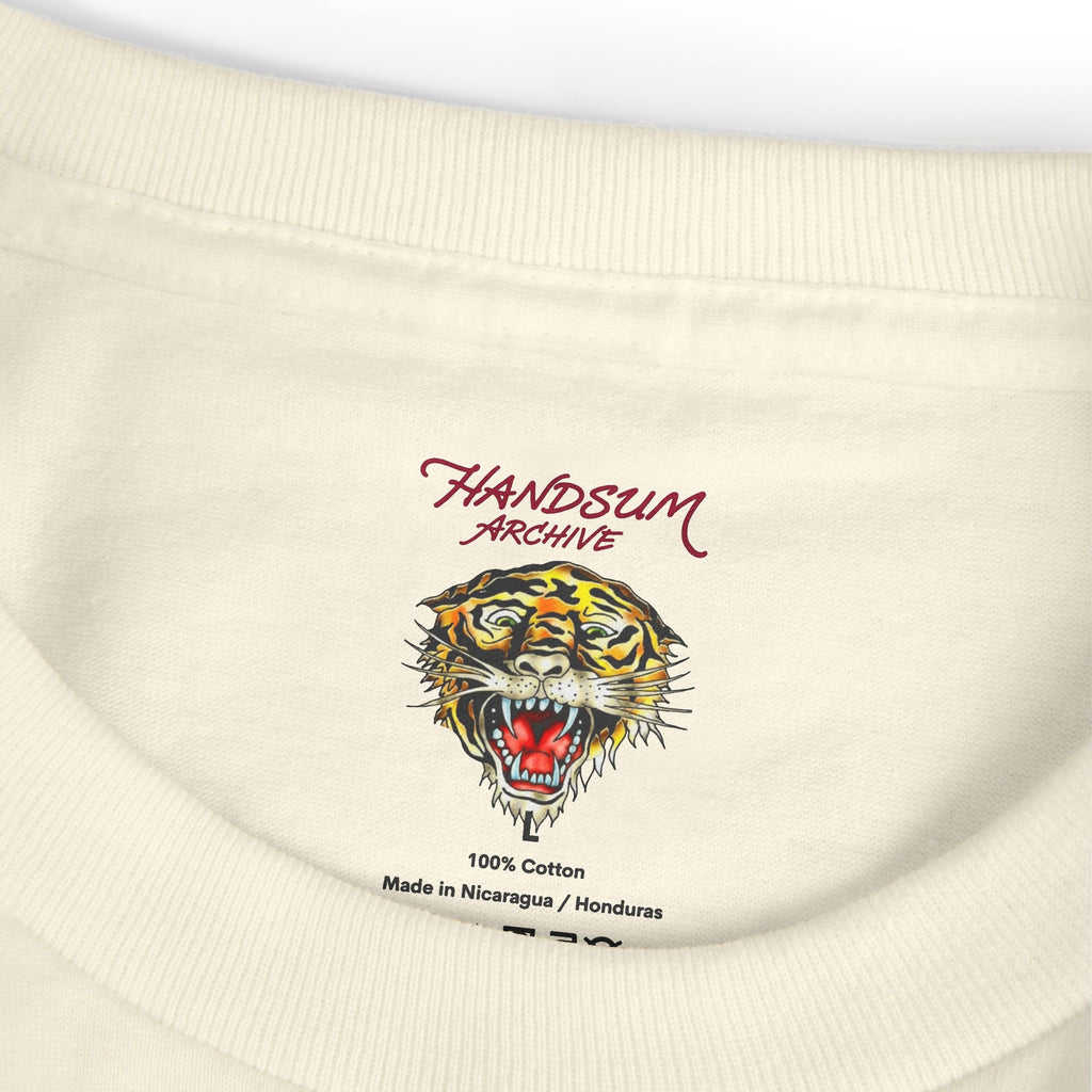 Crewneck collar close-up with embroidered tiger graphic and “100% Cotton” label text
