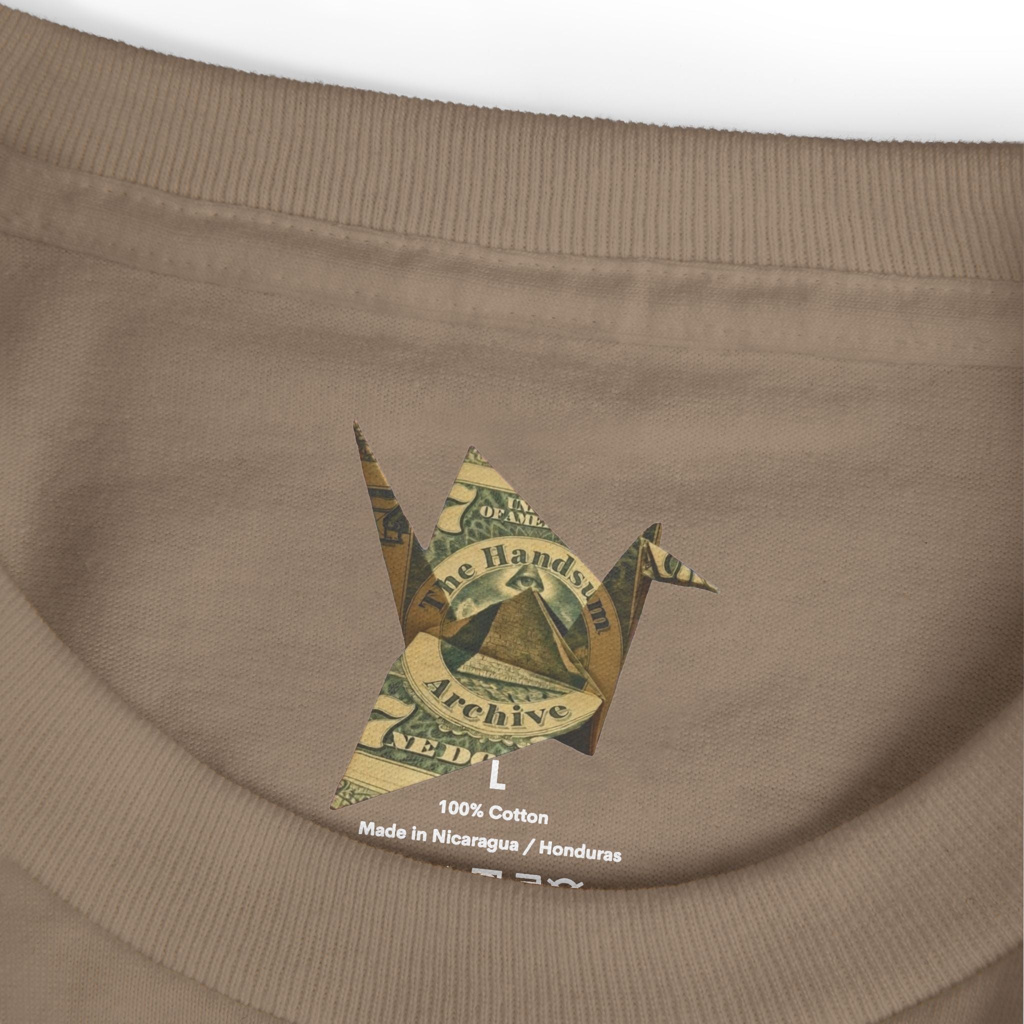 Faded brown T-shirt neckline with 100% cotton label and “Made in Nicaragua / Honduras”