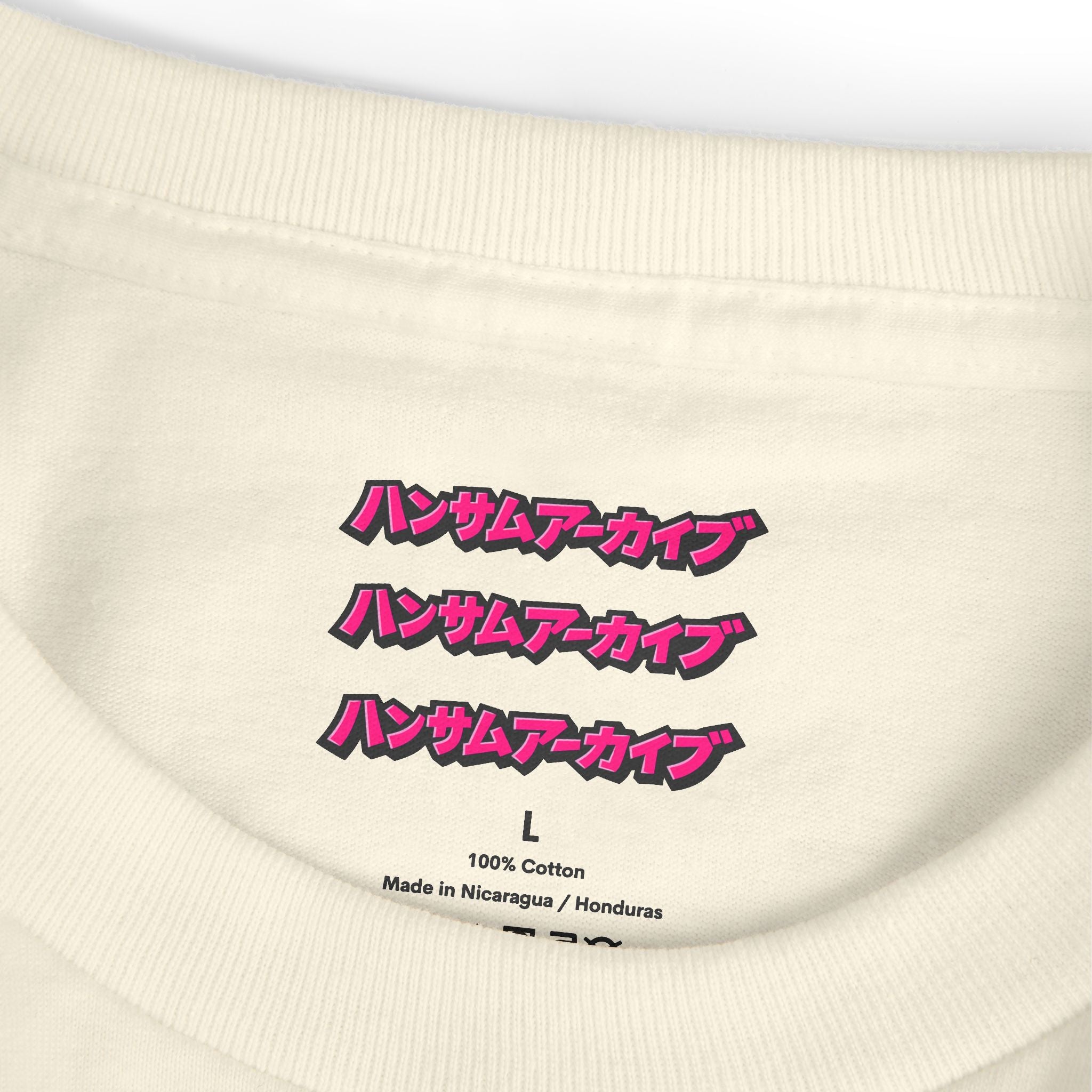 Cream T-shirt neckline close-up showing “100% Cotton” and size label L.