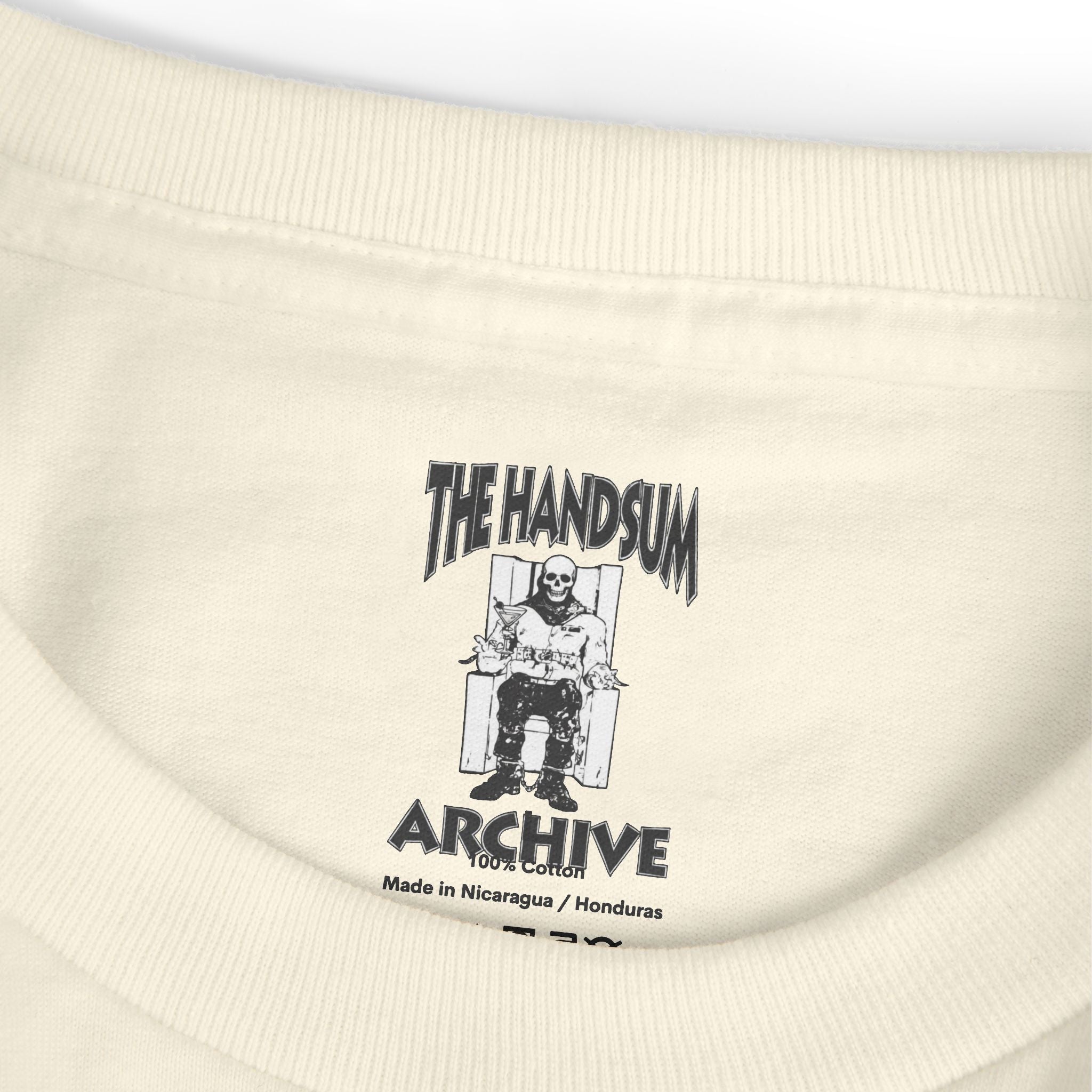 Cream T-shirt neckline with small “The Handsum Archive” graphic and Made in info
