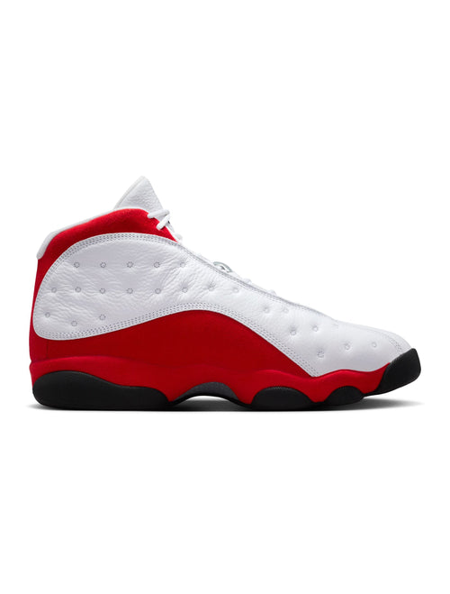 Air Jordan 13 retro sneaker, white upper with red side panel and black rubber outsole.