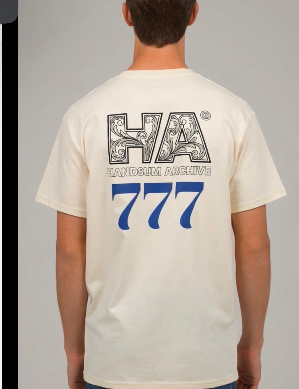 White T-shirt back with decorative "HANDS UM ARCHIVE" and large blue 777 print.