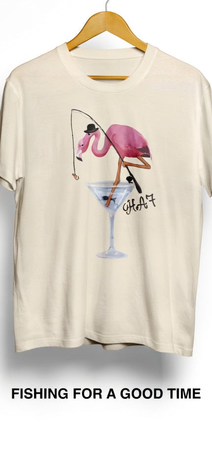 Cream T-shirt hanging on a wooden hanger with pink flamingo martini glass graphic.
