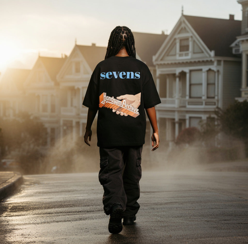 Black Turbo Tee with 'sevens' and orange archive hand graphic on back