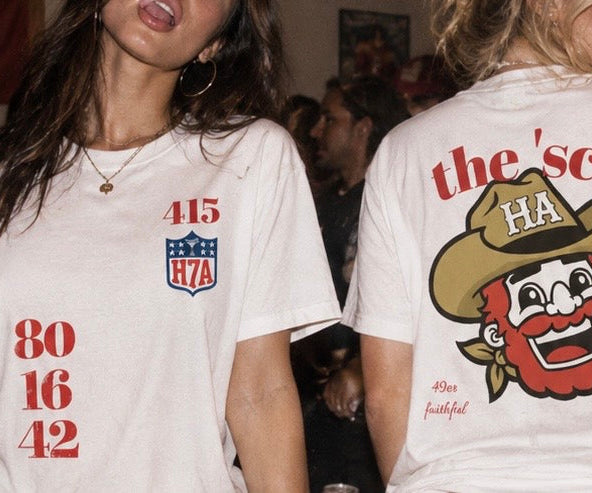White graphic T-shirt with red 415 HZA front print and cartoon logo on back