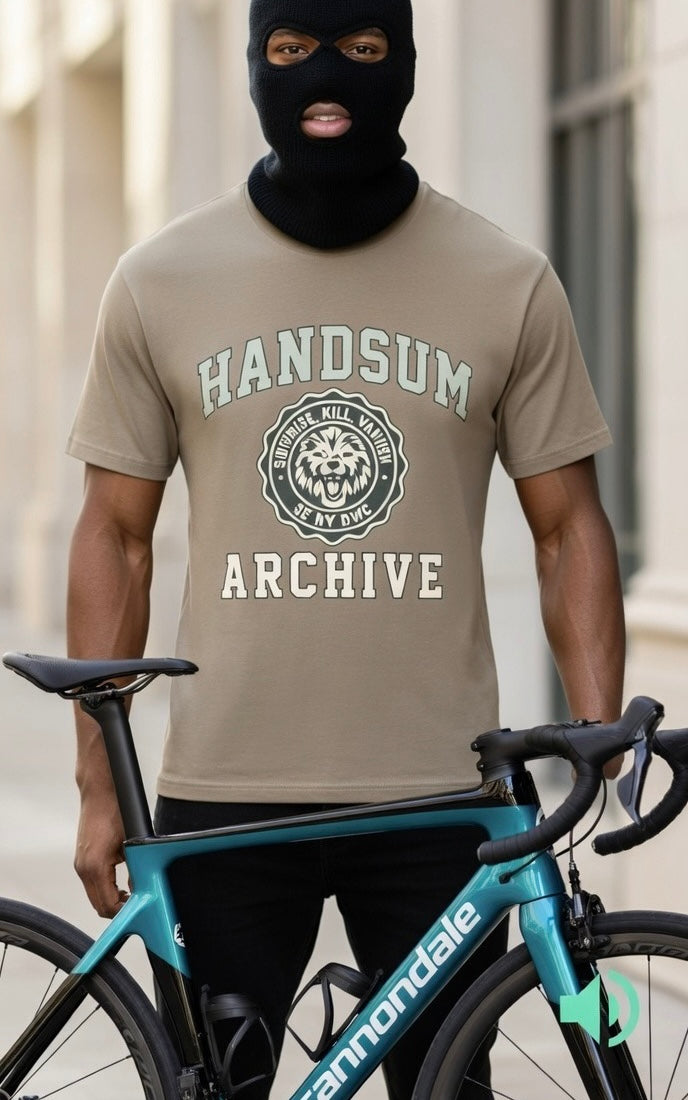 Beige graphic T-shirt with “HANDSUM ARCHIVE” logo on the front; worn with ski mask.