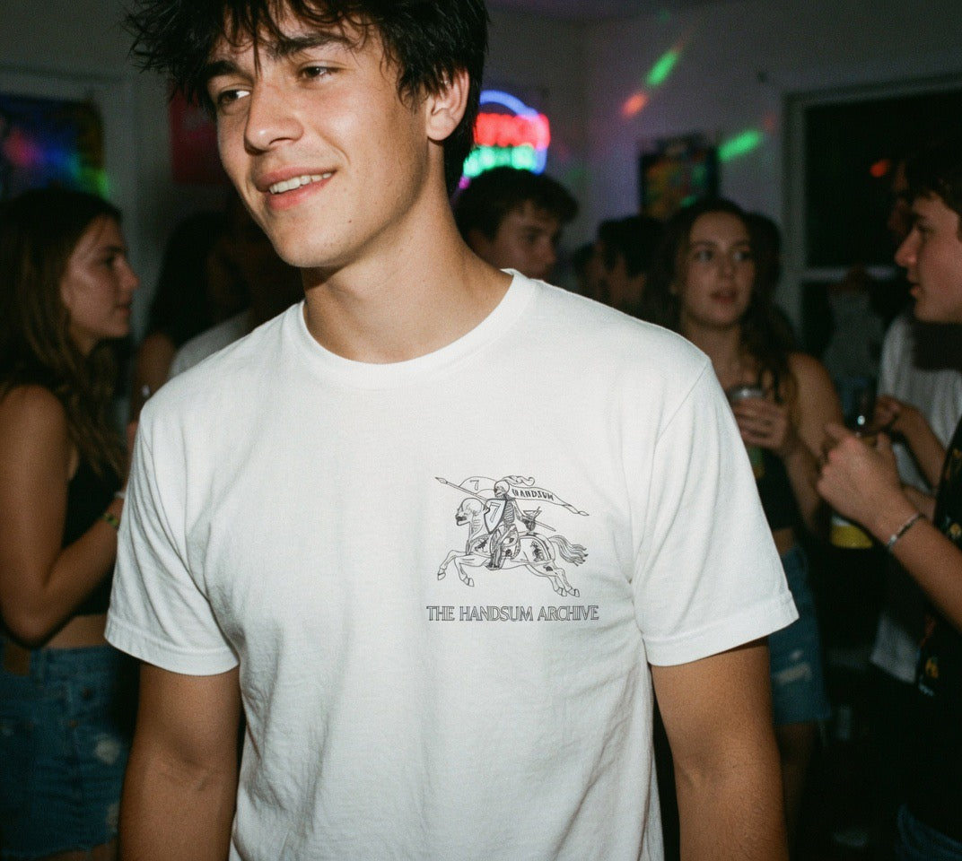 Handsum Island T-shirt, white crewneck with small chest graphic and “THE HANDSUM ARCHIVE”.